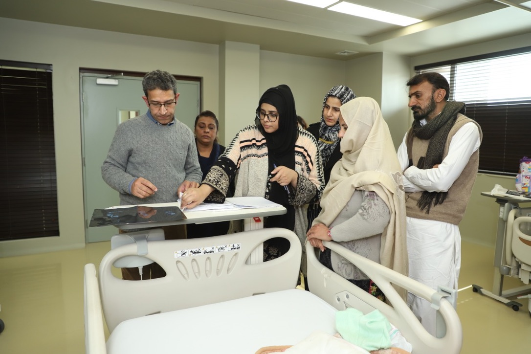 Dr. Abid Qazi with a child patient